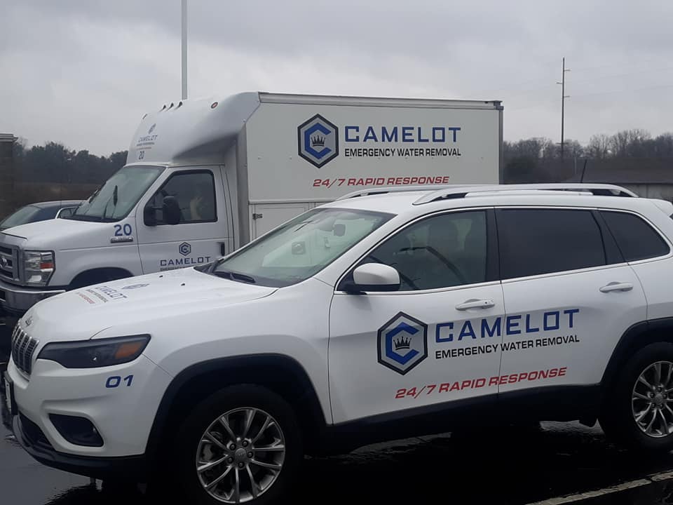 Camelot Emergency Water Removal service vehicles with 24/7 Rapid Response branding in Michigan