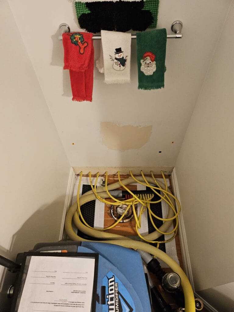 Drying hoses and a dehumidifier where a toilet was removed after a toilet leak in Schoolcraft, Michigan