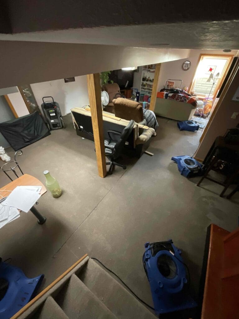 Air movers drying a basement after a sewage backup in Grand Ledge, Michigan